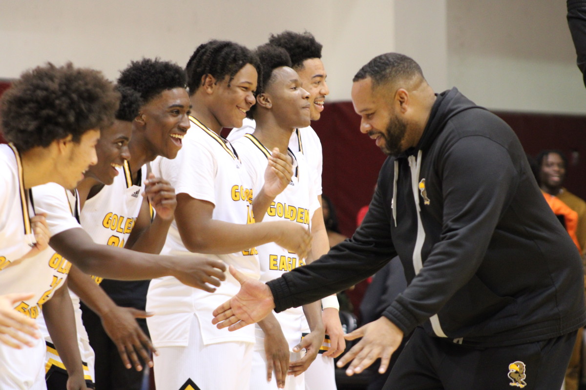King/Drew coach Lloyd Webster celebrates with his team after beating LACES in the LA City Section Open Division final at Pasadena City College on Saturday, Feb. 24, 2024.